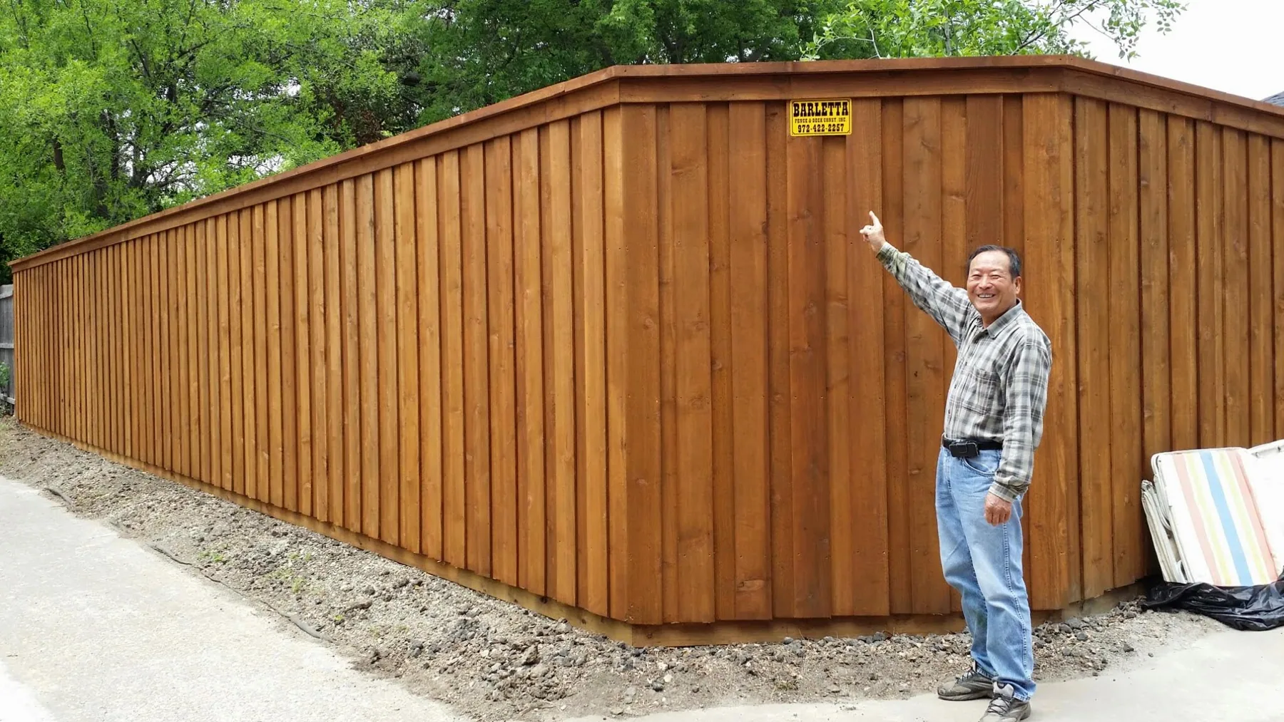 A finished cedar fence with the Barletta plate