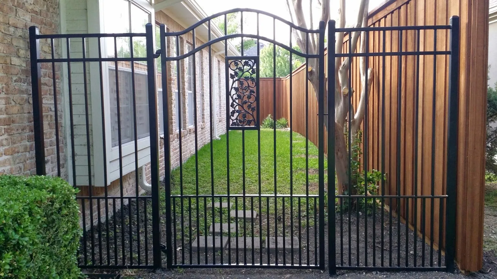 Black metal gate with decorative center detail
