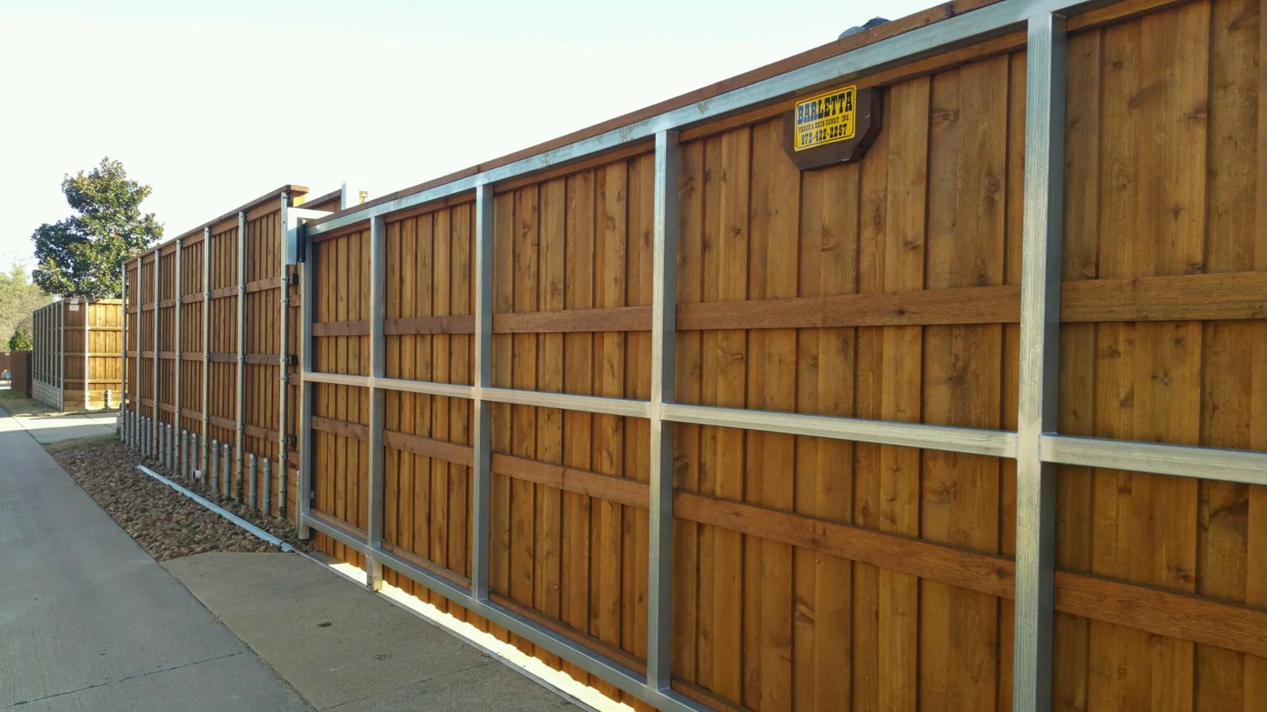 Cedar sliding gate with a metal frame