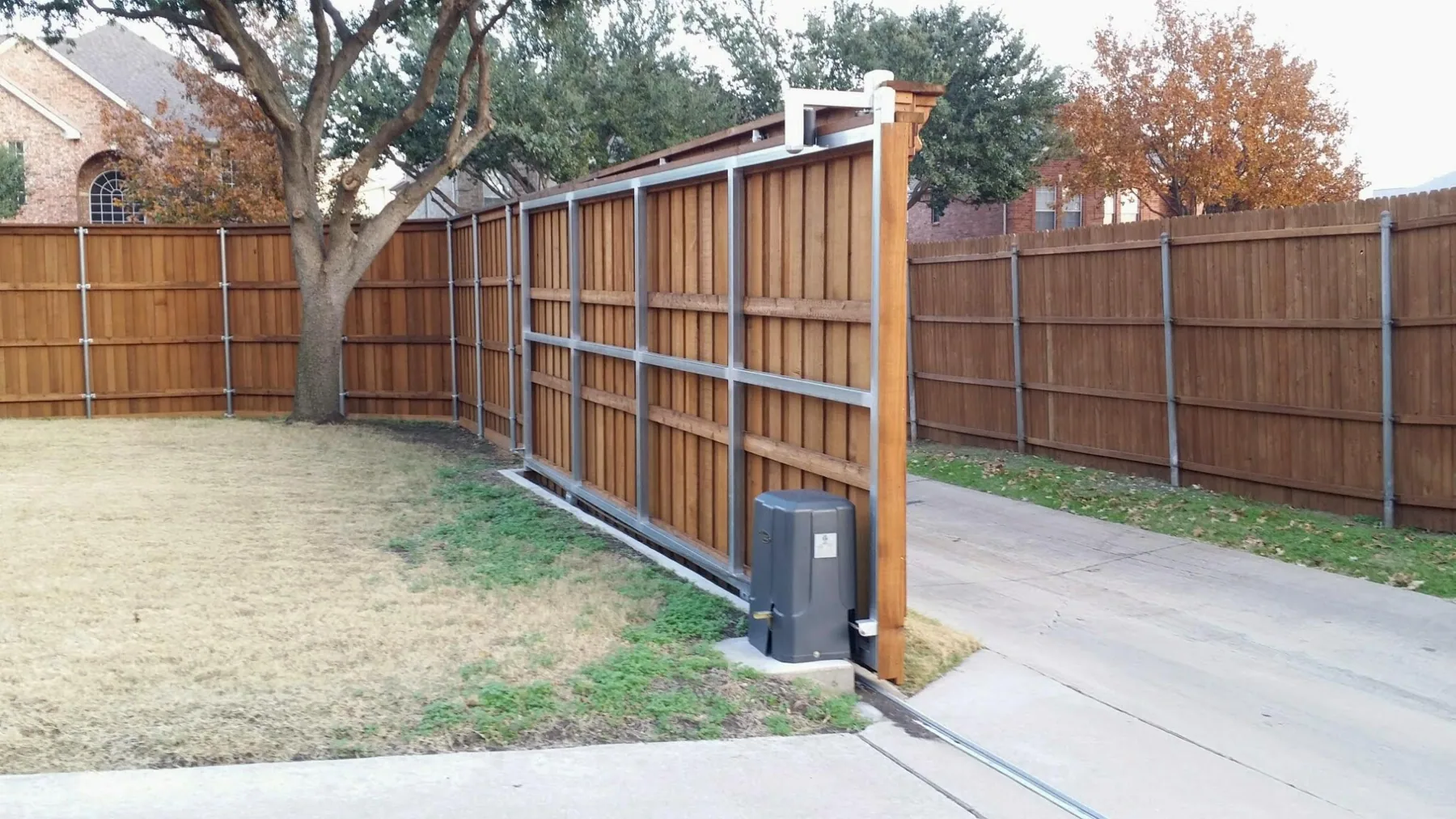 Sliding wood driveway gate with its opener