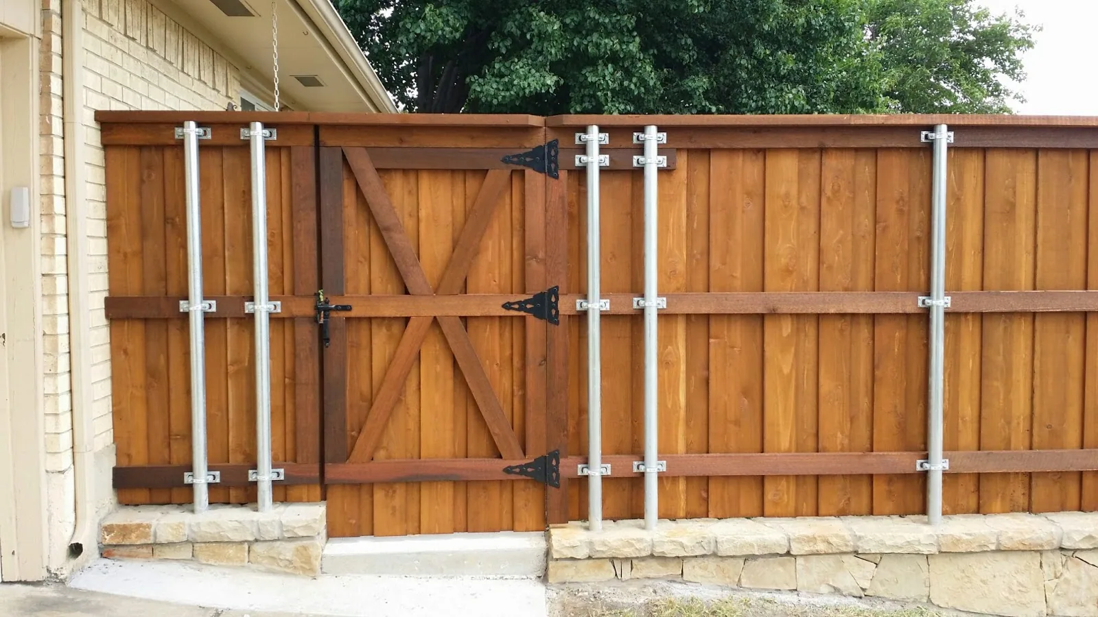 Cedar fence and wooden gate on a stone wall